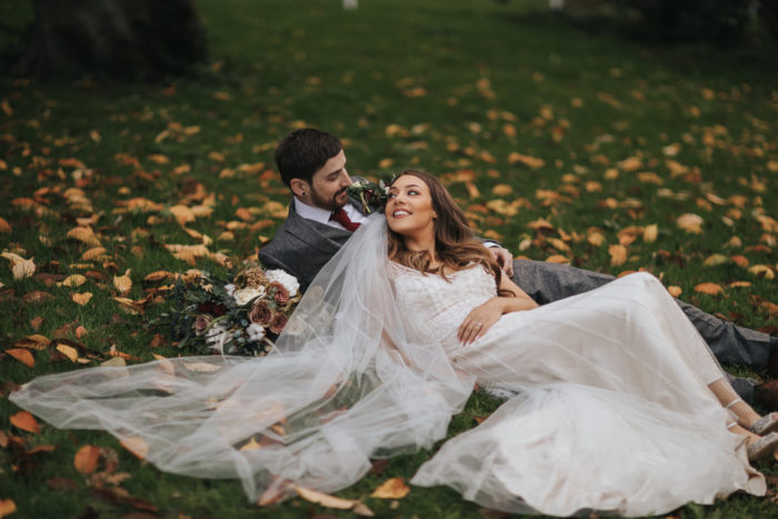 Young,Wedding,Couple,Laid,On,Grass,In,Autumn,November,2018